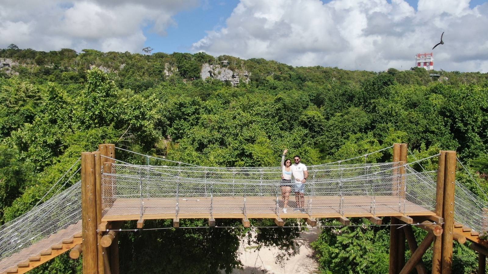 Visitors on a hanging bridge above the forest canopy at Scape Park, Cap Cana