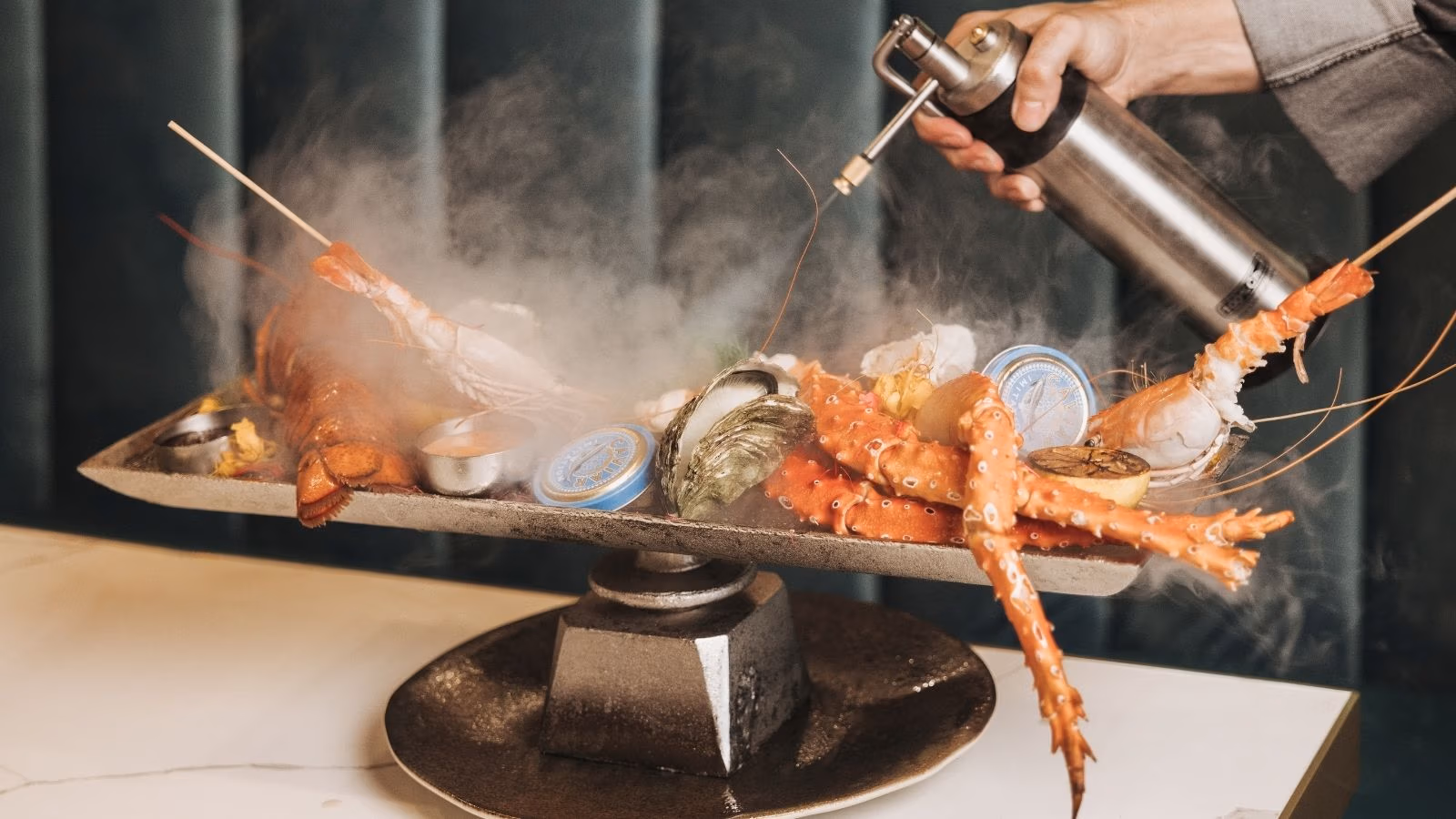 Seafood course served tableside with smoke at The Blind Butcher, Cap Cana