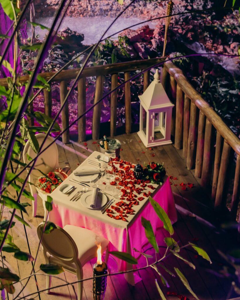 Table with rose petals for a romantic dinner at Eden Roc Cap Cana